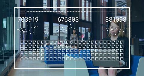 Businesswoman typing on laptop with data overlay in urban lobby
