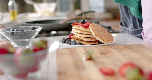 Freshly Made Pancakes with Berries and Syrup in a Modern Kitchen - Download Free Stock Images Pikwizard.com