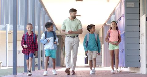 Teacher Walking with Engaged Students in School Hall - Download Free Stock Images Pikwizard.com