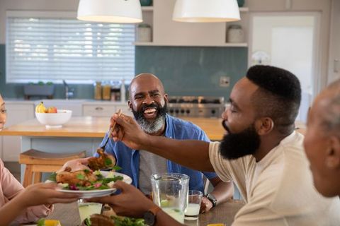 Family Sharing Meal Around Modern Kitchen Table