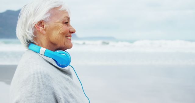 Senior Woman Enjoying Music by the Beach - Download Free Stock Images Pikwizard.com