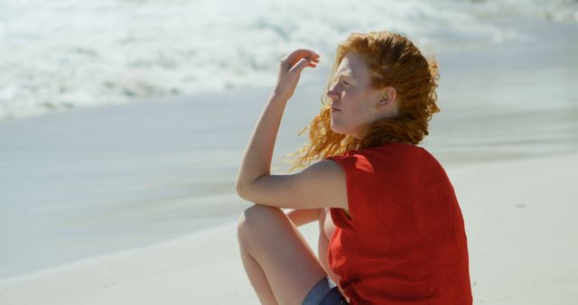 Redhead Woman Seating by Ocean Beach Enjoying Sunny Day - Download Free Stock Images Pikwizard.com