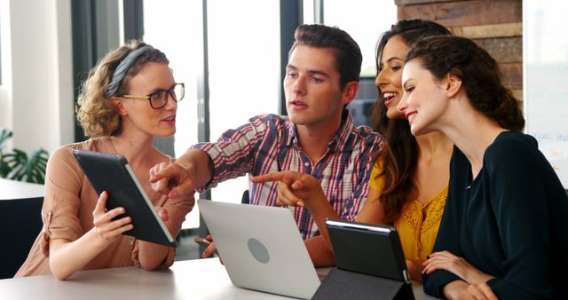 Diverse Colleagues Collaborating on Tablet and Laptop in Office - Download Free Stock Images Pikwizard.com