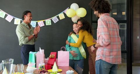 Joyful workplace baby shower gathering with excited colleagues
