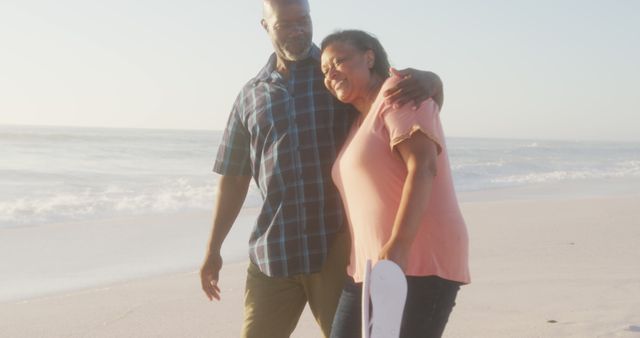 Smiling Mature African American Couple Walking on the Beach Together - Download Free Stock Images Pikwizard.com