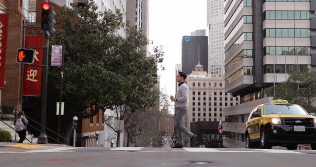 Person Walking in Urban City Street Intersection with Taxi and Skyscrapers - Download Free Stock Images Pikwizard.com