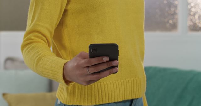 Person Using Smartphone in Casual Yellow Sweater at Home - Download Free Stock Images Pikwizard.com