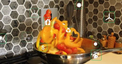 Tossing Peppers and Tomatoes in Stainless Steel Pan