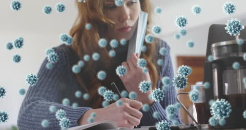 Virus Overlay on Woman with Mask Doing Remote Work