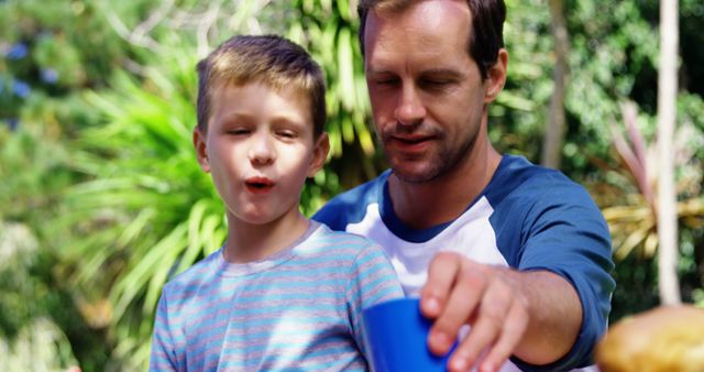 Father and Son Enjoying Outdoor Picnic on Sunny Day - Download Free Stock Images Pikwizard.com