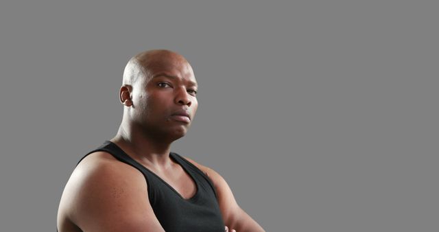 Confident African American Man with Crossed Arms on Gray Background - Download Free Stock Images Pikwizard.com