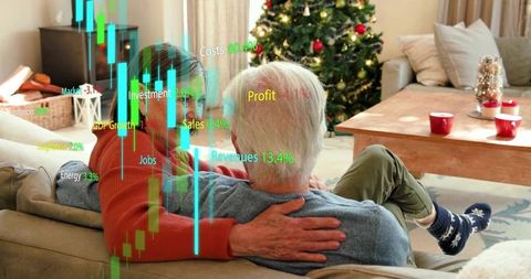 Senior couple cuddling on sofa by christmas tree with financial charts overlay
