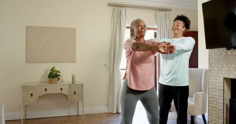 Senior Mother and Son Bonding During Home Exercise Routine
