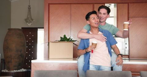 Diverse Couple Unpacking in New Home Kitchen