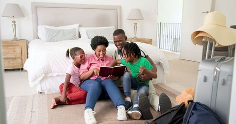 Joyful Family Sharing Special Moments in Cozy Bedroom