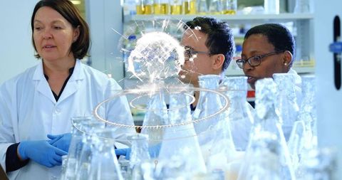 Diverse scientists collaborating, analyzing flasks with holographic data visualization