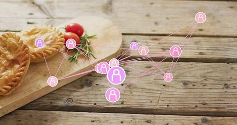 Pink social network overlay connecting nodes across rustic wooden table with pastries