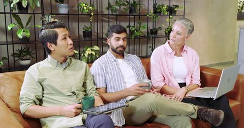 Diverse team collaboration in modern lounge workspace