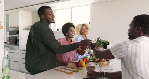 Friends Toasting at Kitchen Island During Gathering