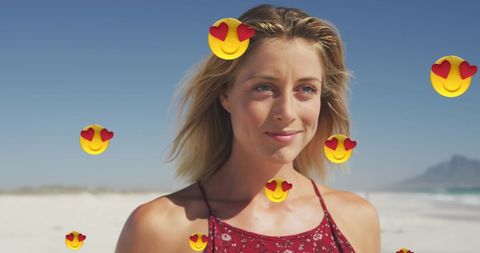 Smiling Woman at Beach with Heart Emojis Overlay