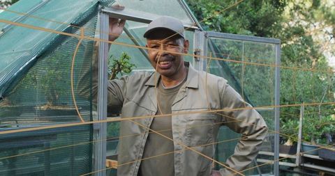 Mature gardener smiling in rustic home garden