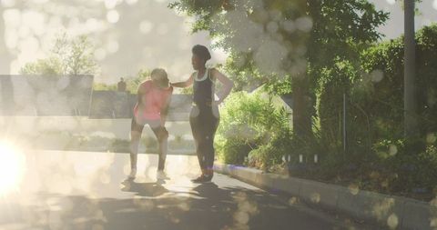 Fitness Enthusiasts Training Together Outdoors in Bright Sunlight
