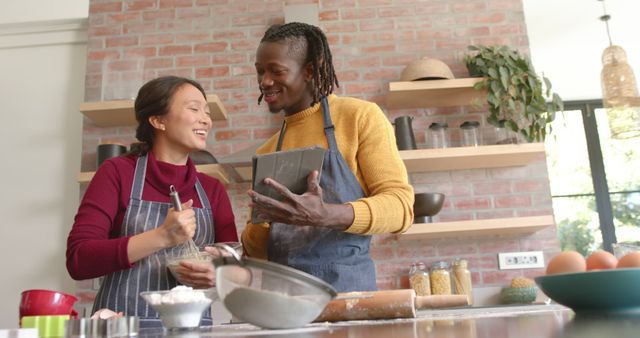 Mixed race couple baking and enjoying quality time in kitchen - Download Free Stock Images Pikwizard.com