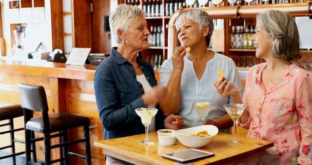 Three Senior Women Enjoying Drinks and Snacks in Café - Download Free Stock Images Pikwizard.com