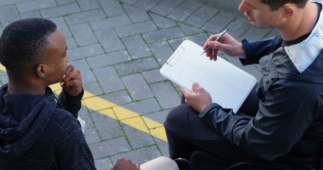 Coach Discussing Performance Plans with Young Athlete Outdoors - Download Free Stock Images Pikwizard.com