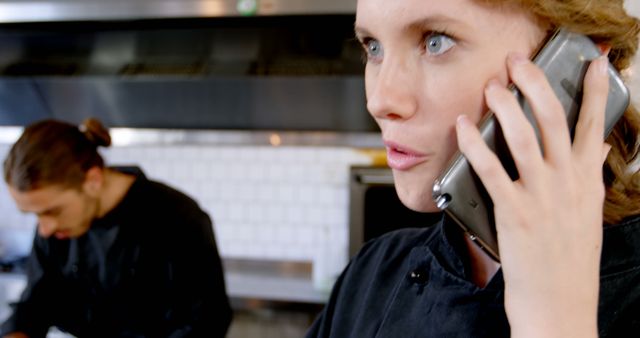 Busy Female Chef Taking Call in Commercial Kitchen - Download Free Stock Images Pikwizard.com