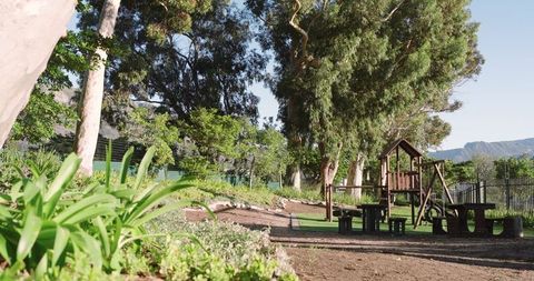 Peaceful playground with wooden playset amidst nature