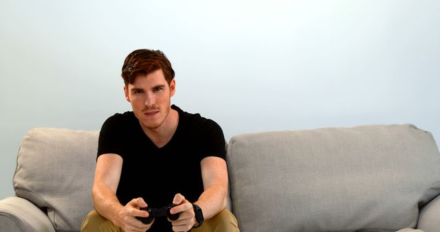 Young Man Enthusiastically Playing Video Games on Sofa - Download Free Stock Images Pikwizard.com