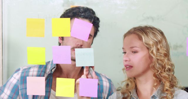 Young Professionals Brainstorming Ideas with Sticky Notes on Glass Wall - Download Free Stock Images Pikwizard.com