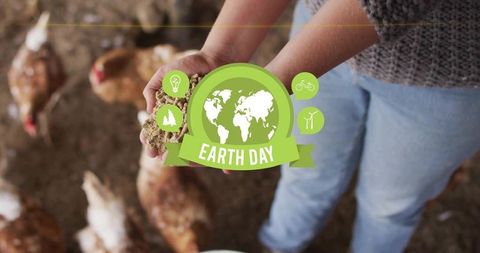 Earth Day farmhand feeding free-range chickens in barnyard, sustainable agriculture