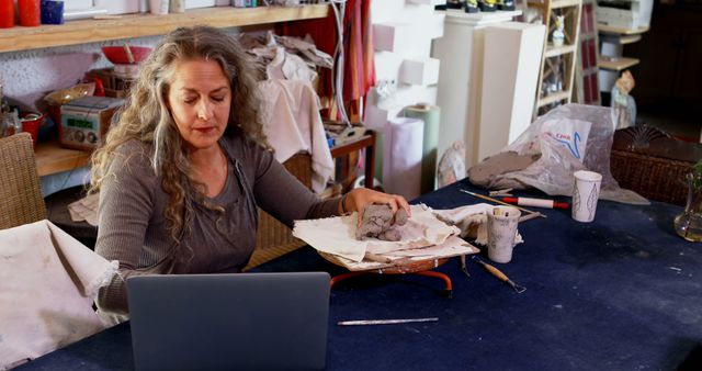 Mature Female Artist Sculpting Clay at Desk - Download Free Stock Images Pikwizard.com