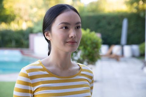 Young Woman Relaxing by Poolside on Sunny Day