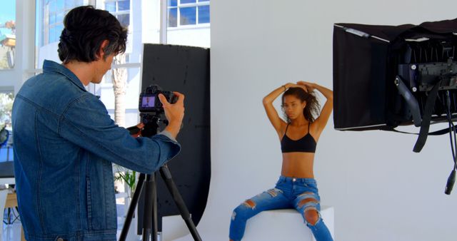 Photographer taking pictures of a model in studio setting - Download Free Stock Images Pikwizard.com