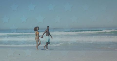 Romantic african american couple walking on sunny beach
