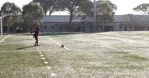 Soccer Player Preparing for Match on Sunny Field