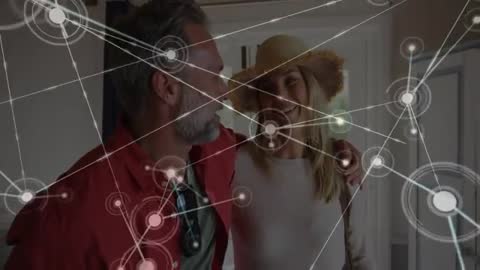 Couple Embracing Smart Technology at Home with Digital Network Overlay
