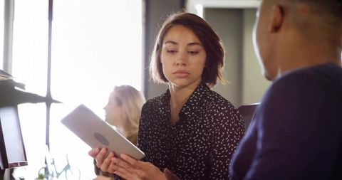 Professionals Collaborating in Modern Office with Technology