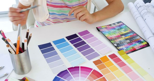 Designer Organizing Color Swatches and Palettes in Creative Workspace - Download Free Stock Images Pikwizard.com