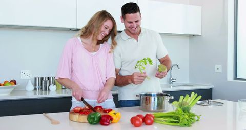 Happy Couple Cooking Healthy Meal Together in Modern Kitchen