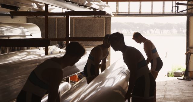 Rowing Team Preparing Canoe in Boat Shed - Download Free Stock Images Pikwizard.com