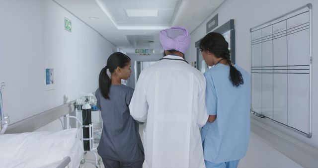 Medical Team Walking Through Hospital Corridor - Download Free Stock Images Pikwizard.com