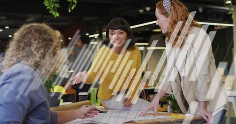 Creative Business Team Collaborating on Office Blueprint Project