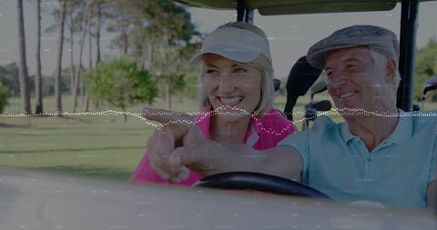 Happy couple enjoying leisurely golf cart ride on green fairway