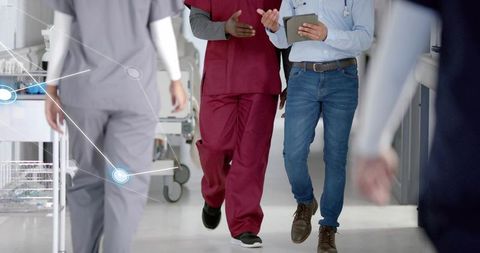 Doctor and Nurse Collaborating in Hospital Hallway