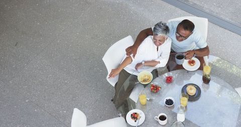 Midlife Couple Enjoying Breakfast in Modern Dining Area