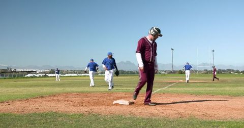 Baseball Player Stepping on Base in Sunny Outdoor Game